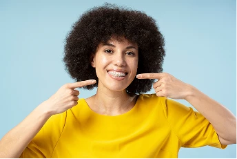 Woman pointing at her smile